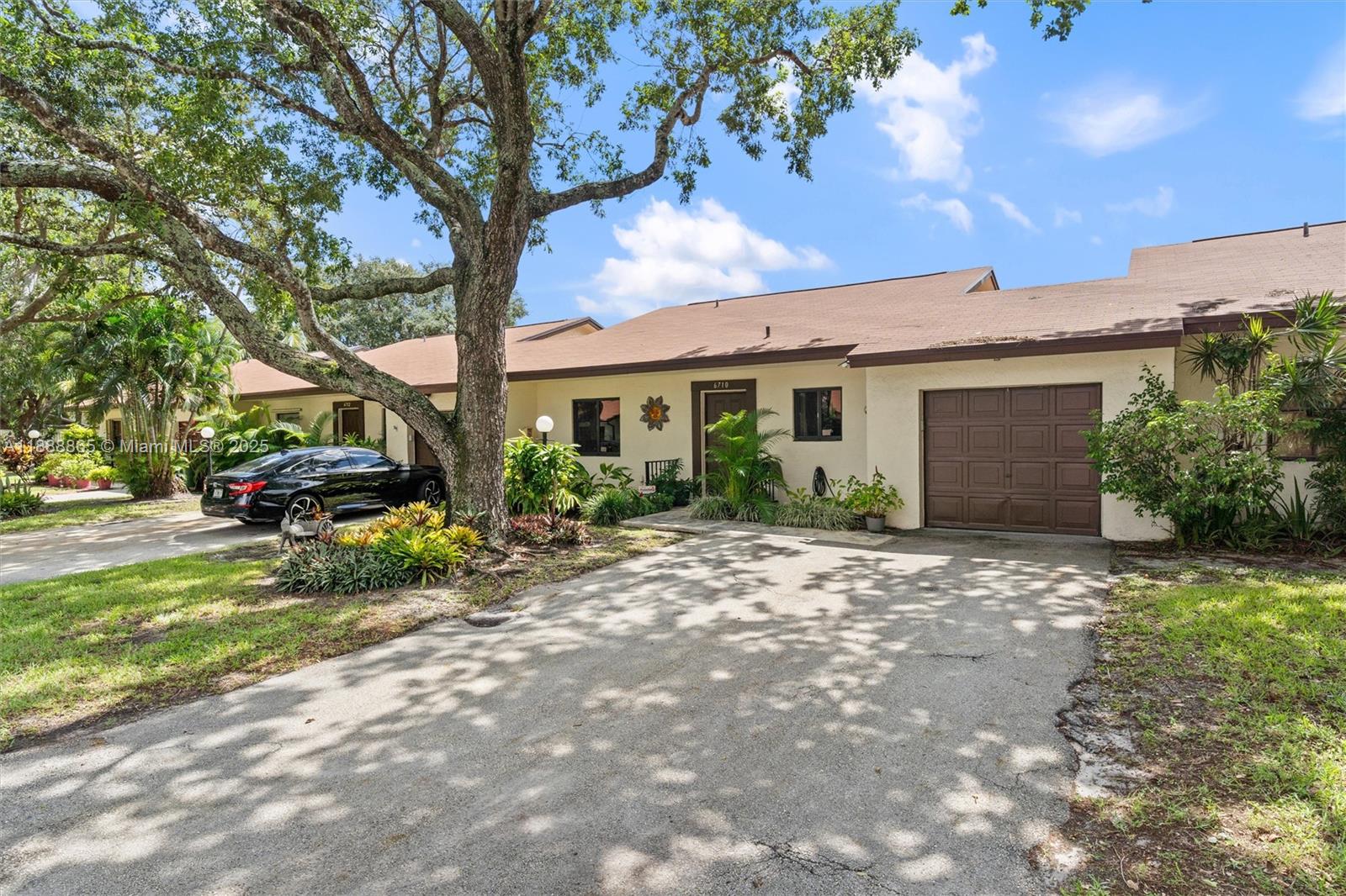 6710 South Parkway Drive, Unit 311 Margate, FL 33068 - Photo 1 of 31 a view of a house with a yard and garage