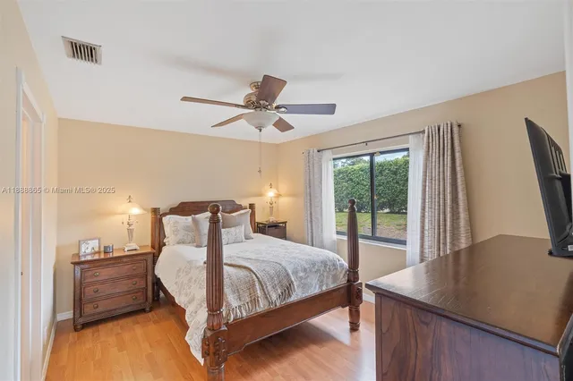 a bedroom with a large bed and a large window