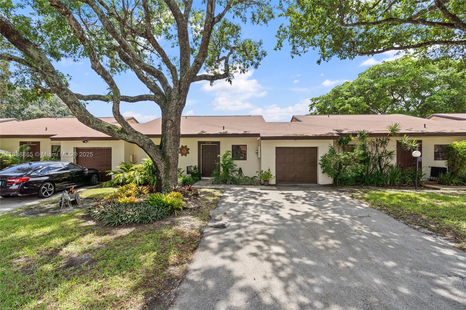 6710 South Parkway Drive, Unit 311 Margate, FL 33068 - Photo 2 of 31 a front view of a house with garden