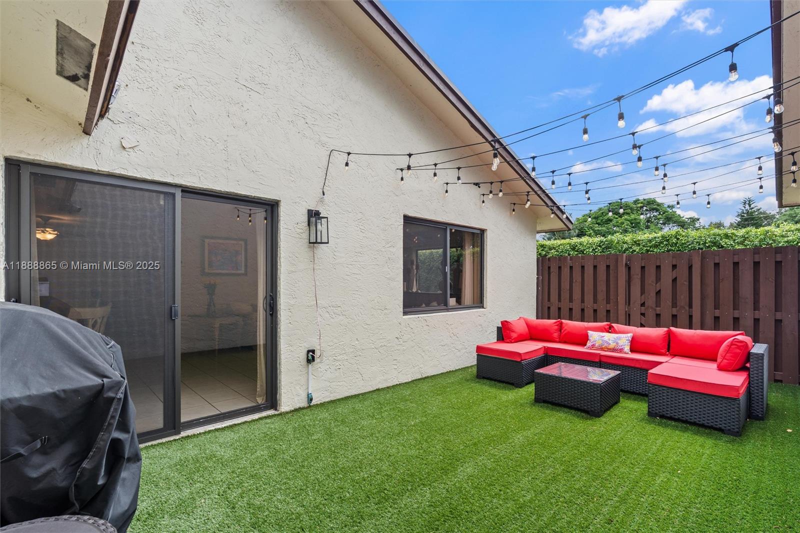 6710 South Parkway Drive, Unit 311 Margate, FL 33068 - Photo 23 of 31 a backyard of a house with table and chairs