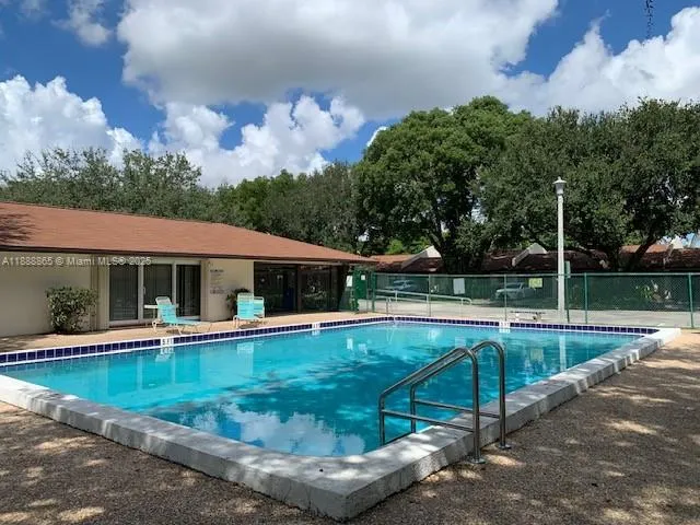 a view of a house with swimming pool and sitting area