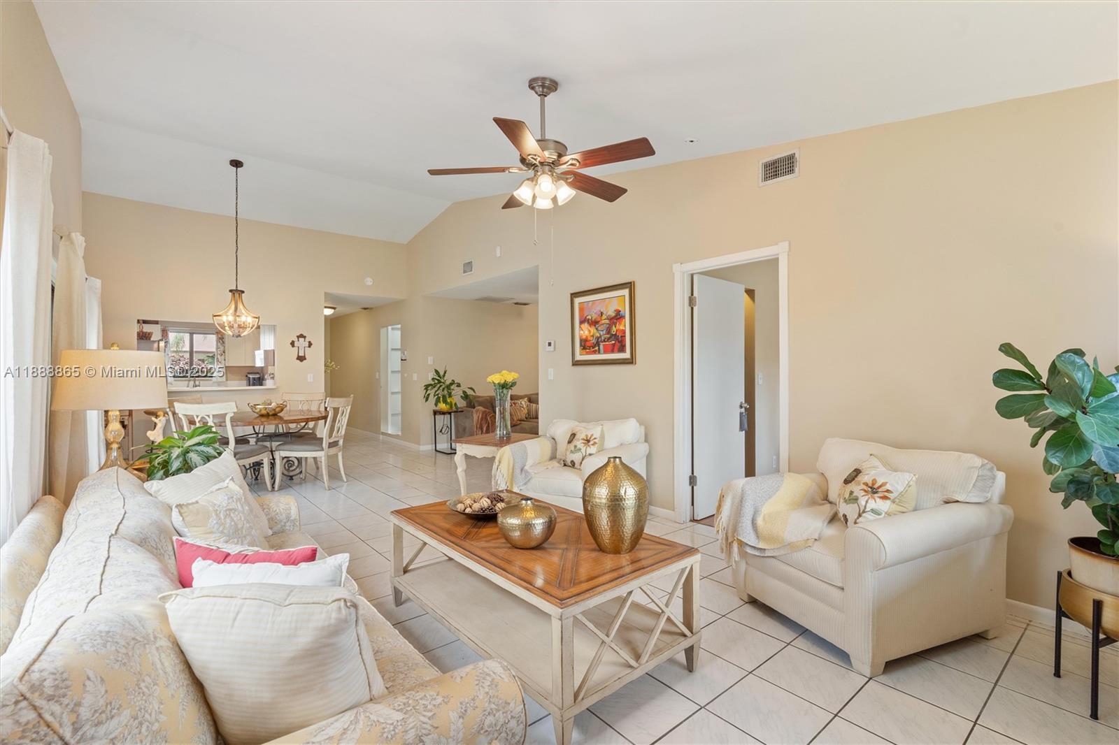6710 South Parkway Drive, Unit 311 Margate, FL 33068 - Photo 7 of 31 a living room with furniture and a chandelier