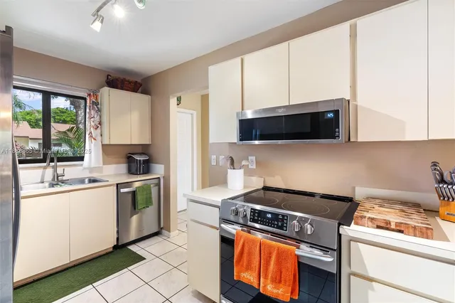 a kitchen with a stove a sink and a microwave