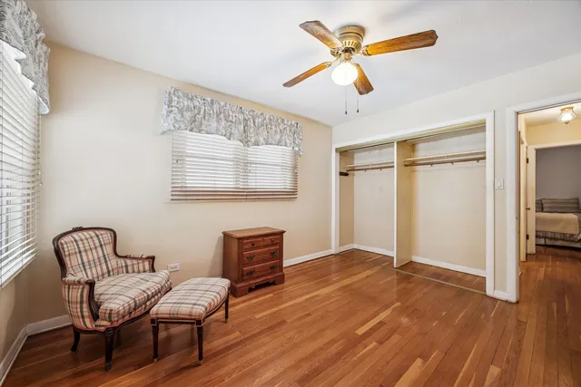 a view of workspace with wooden floor ceiling fan