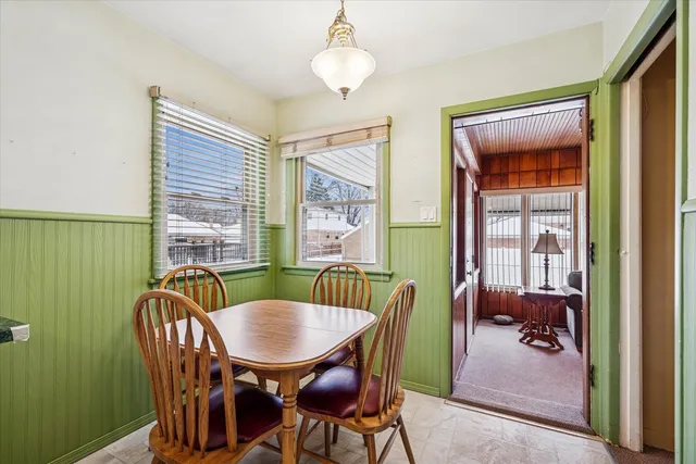 a view of a dining room with furniture wooden floor and a chandelier
