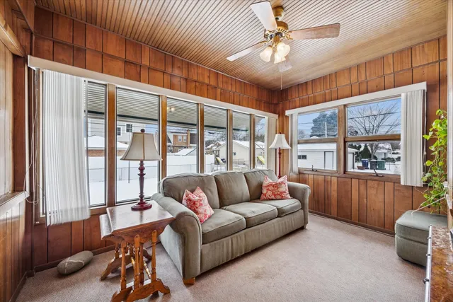 a living room with furniture and a floor to ceiling window