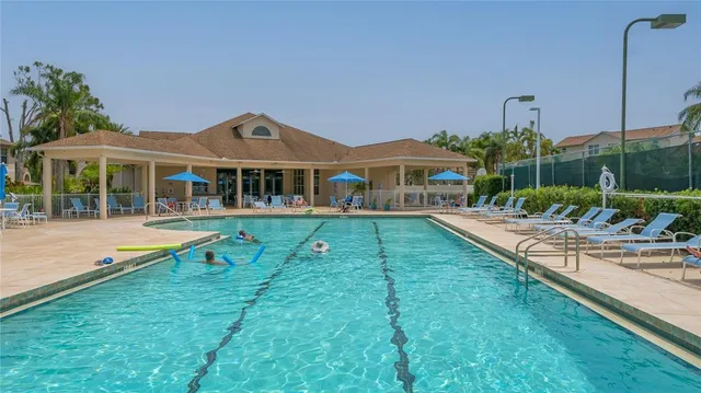 a view of a house with a yard patio and swimming pool