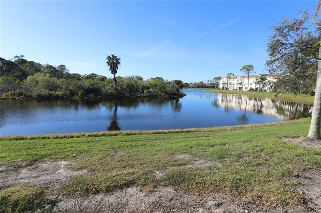 a view of a lake with houses in the back