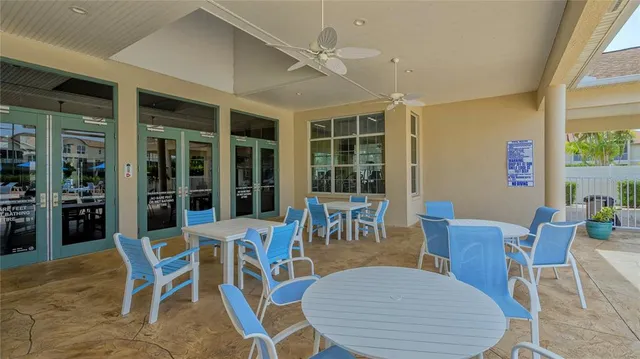 a building outdoor space with patio furniture and potted plants