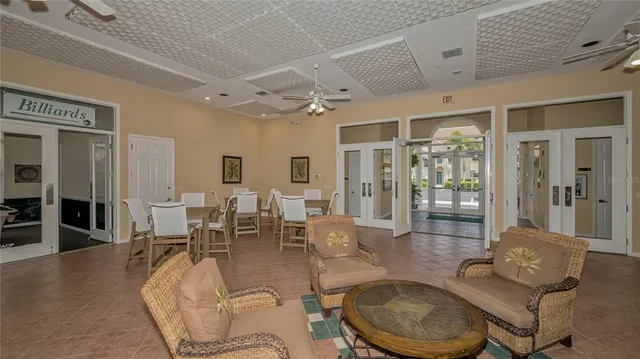 a living room with lots of furniture and a view of kitchen