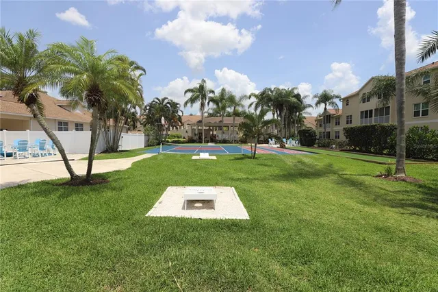 a front view of a house with outdoor seating and barbeque oven