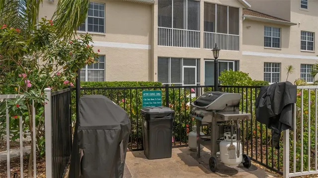 a view of a patio with table and chairs and potted plants
