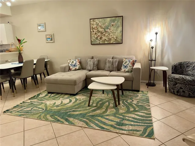a living room with furniture and a rug