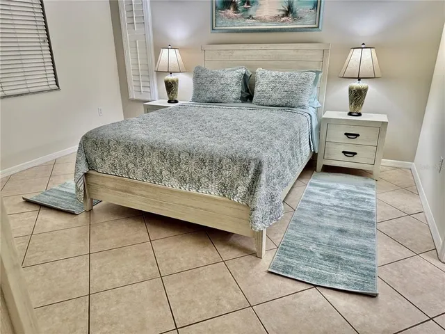 a bedroom with a bed and a lamp on table