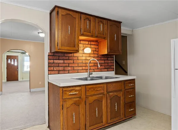 a kitchen with stainless steel appliances granite countertop a stove a sink dishwasher and a microwave oven with cabinets