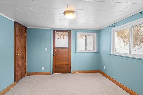 a view of a room with an entryway and wooden floor