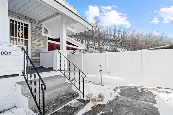 a view of a house with a yard covered in snow