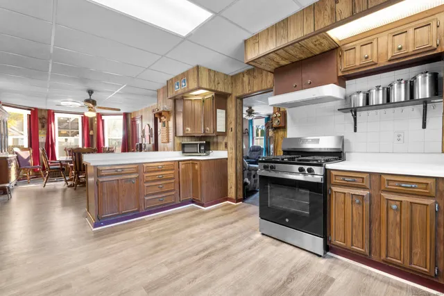 a kitchen with stainless steel appliances granite countertop a stove a sink and a refrigerator