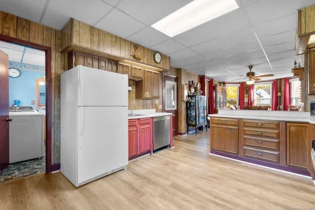 a kitchen with stainless steel appliances granite countertop a refrigerator and a stove