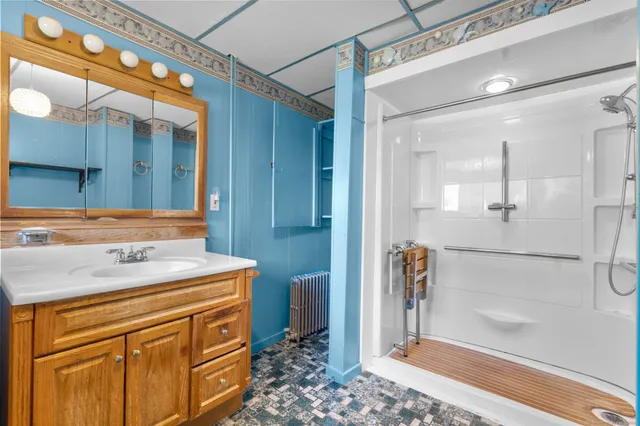 a bathroom with a sink a toilet and shower