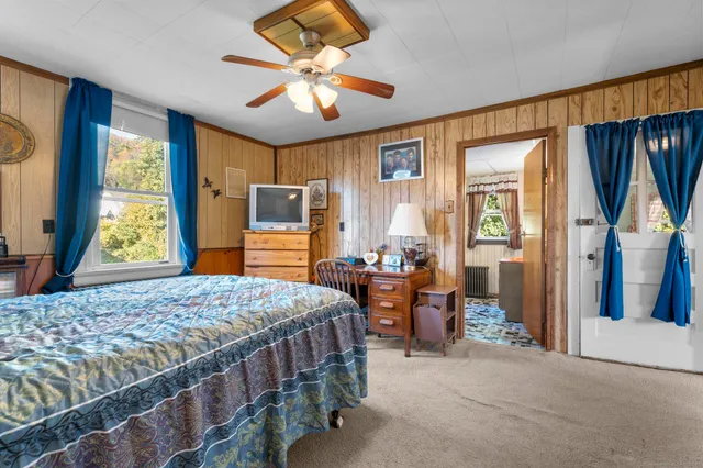 a bedroom with a bed and a chandelier