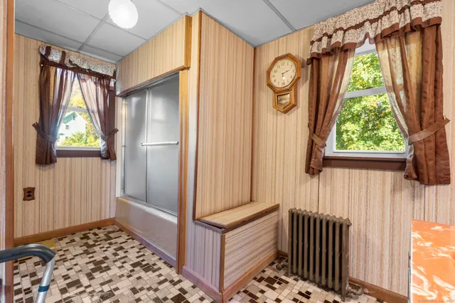 a view of a hallway with wooden door and stairs