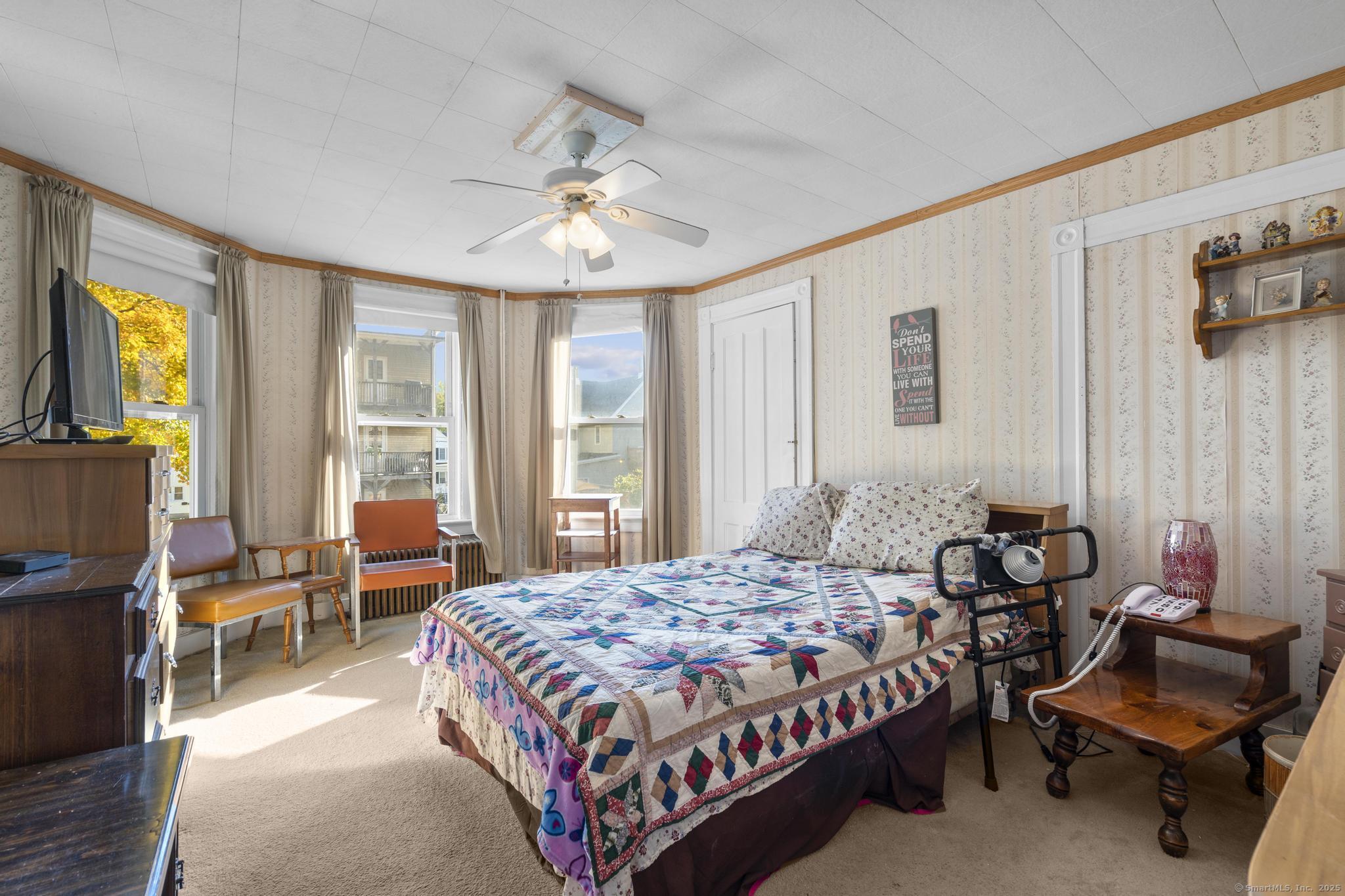 13 French Street Ansonia, CT 06401 - Photo 22 of 40 a bedroom with a bed and a chandelier