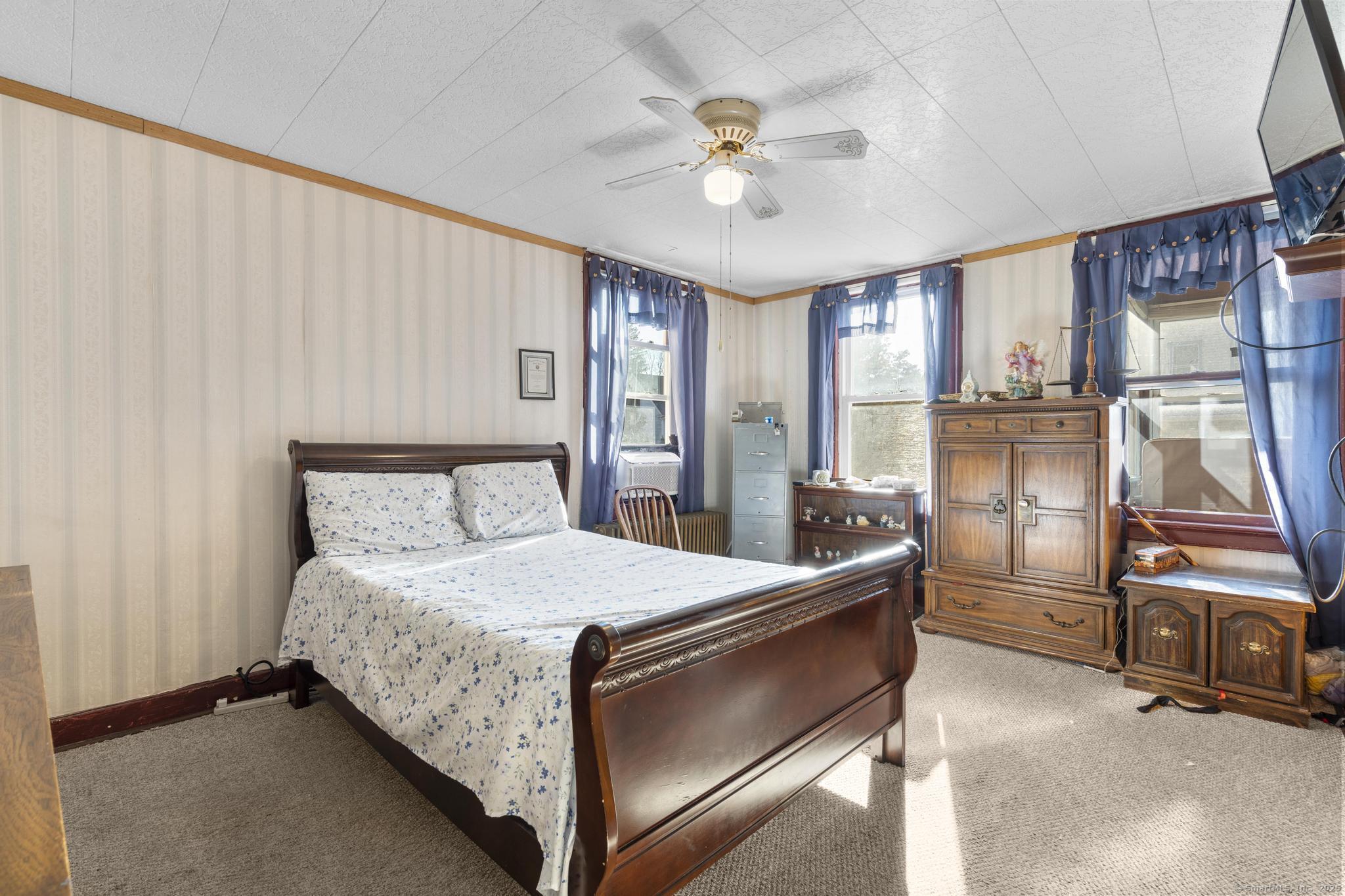 13 French Street Ansonia, CT 06401 - Photo 24 of 40 a bedroom with a bed and a chandelier