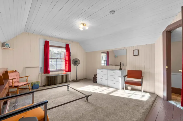 a bedroom with furniture and a window