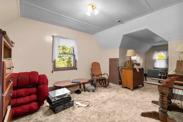 a living room with furniture gym equipment and a window