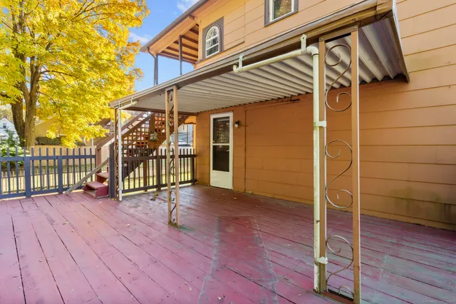 a view of a house with wooden deck