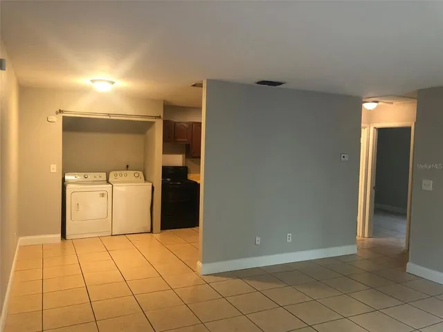 a utility room with cabinets washer and dryer