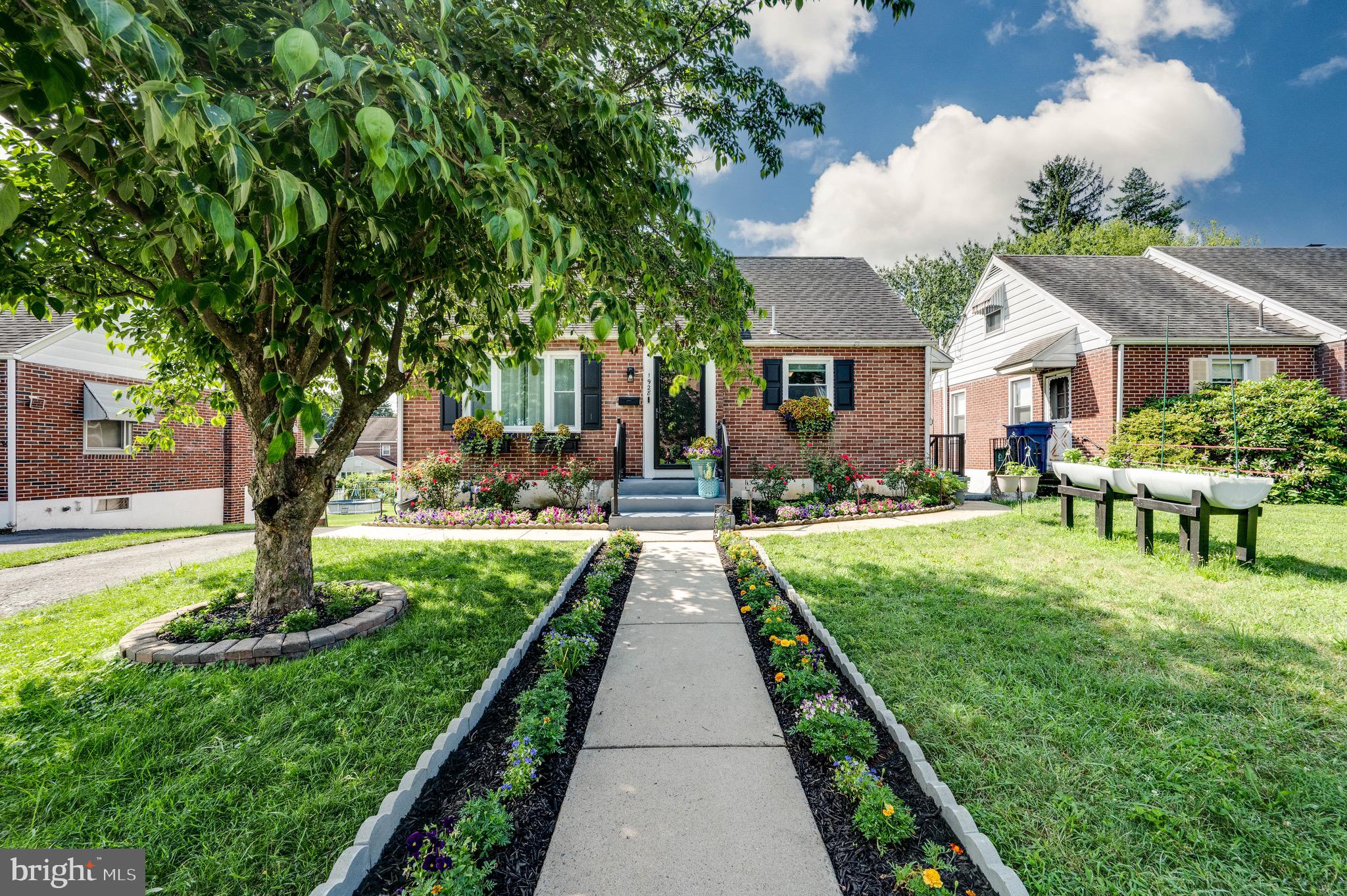 a front view of a house with garden