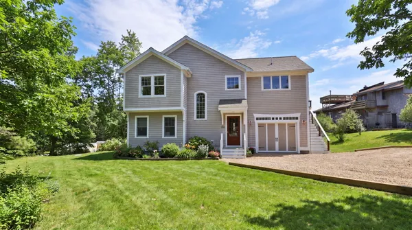 a front view of house with yard and green space