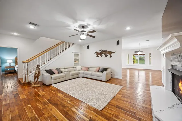 a living room with furniture and a wooden floor