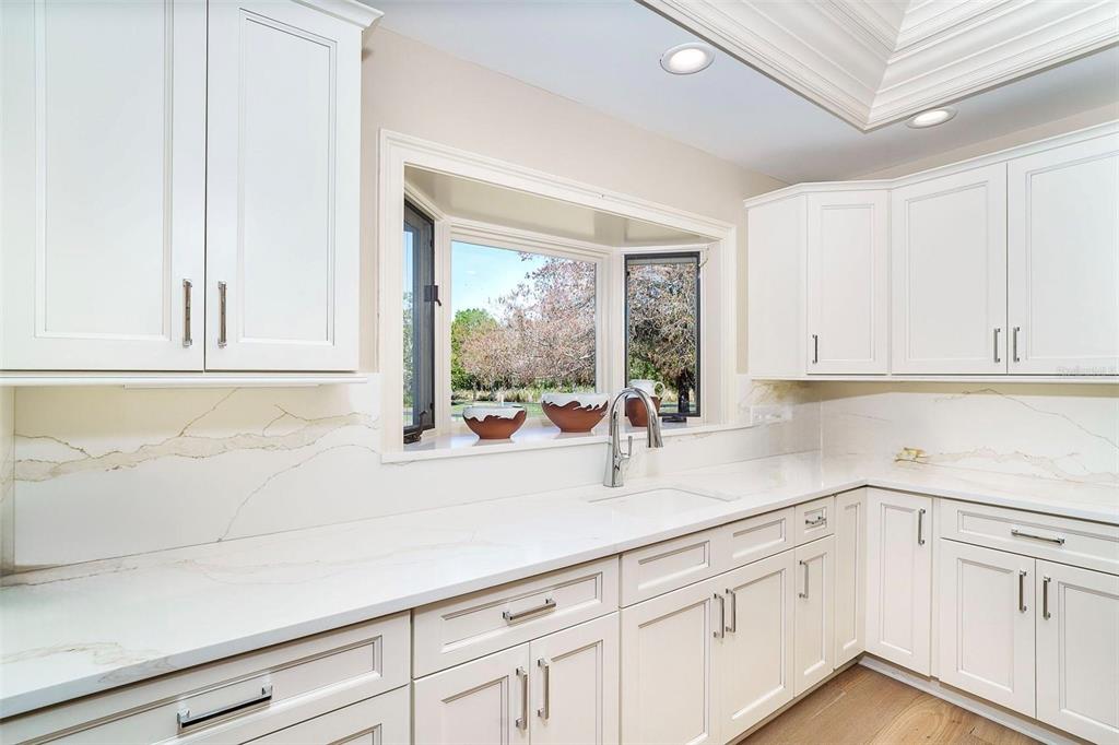 9299 Southwest Lipe Road Arcadia, FL 34269 - Photo 12 of 68 a kitchen with white cabinets and a window