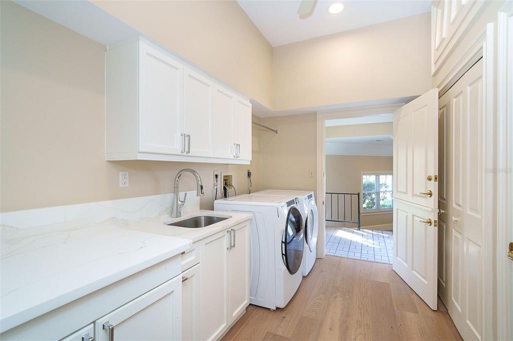 9299 Southwest Lipe Road Arcadia, FL 34269 - Photo 17 of 68 a view of washer and dryer with kitchen in the background