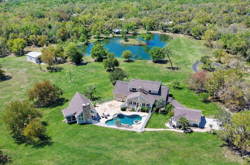 9299 Southwest Lipe Road Arcadia, FL 34269 - Photo 2 of 68 an aerial view of a house with a garden and lake view