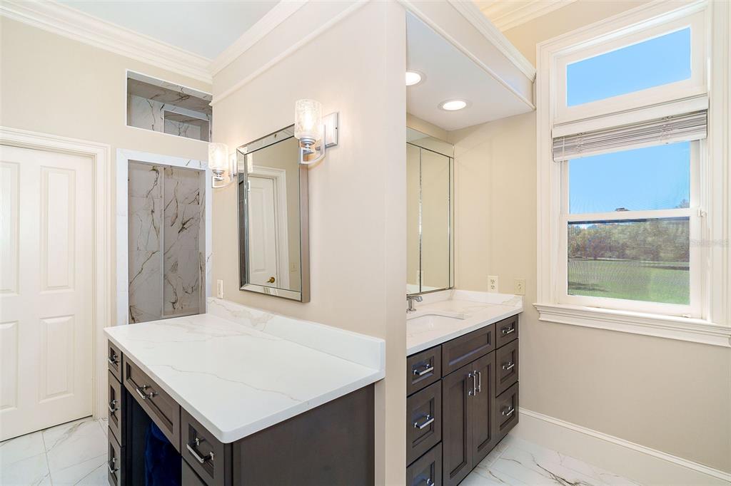 9299 Southwest Lipe Road Arcadia, FL 34269 - Photo 22 of 68 a bathroom with a sink double vanity and a shower