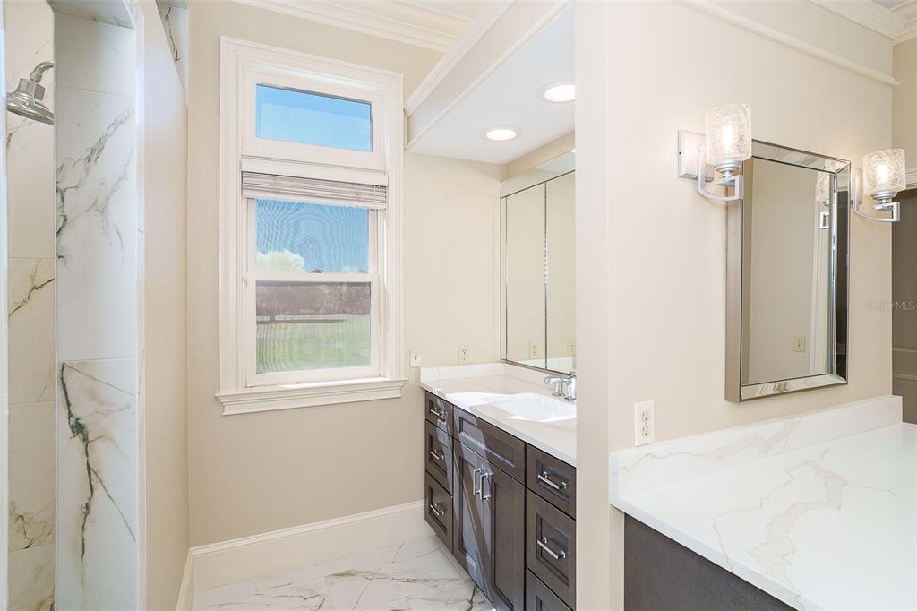 9299 Southwest Lipe Road Arcadia, FL 34269 - Photo 23 of 68 a bathroom with a sink double vanity and a shower