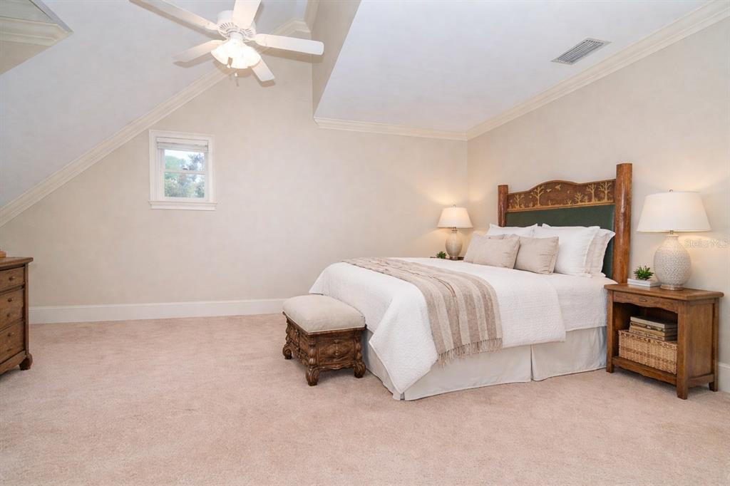 9299 Southwest Lipe Road Arcadia, FL 34269 - Photo 30 of 68 a bed room with a bed and a chandelier