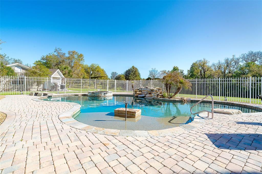 9299 Southwest Lipe Road Arcadia, FL 34269 - Photo 36 of 68 a view of swimming pool with seating space and yard in the back
