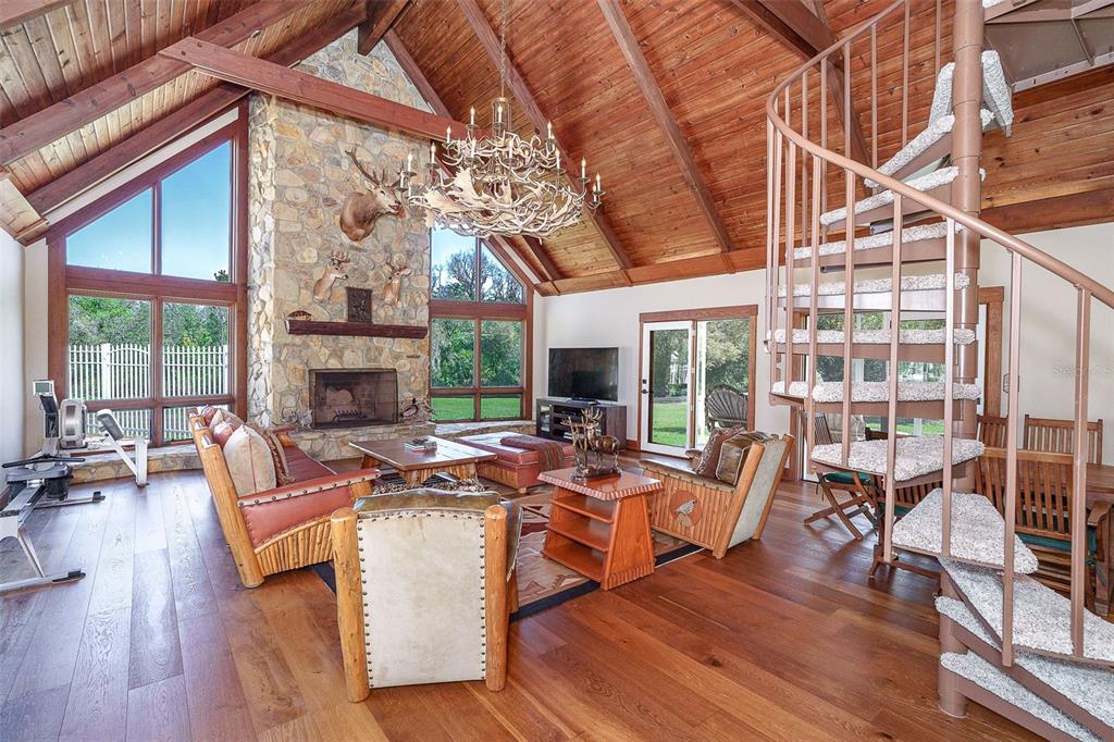 9299 Southwest Lipe Road Arcadia, FL 34269 - Photo 43 of 68 a living room with furniture a fireplace and a large window