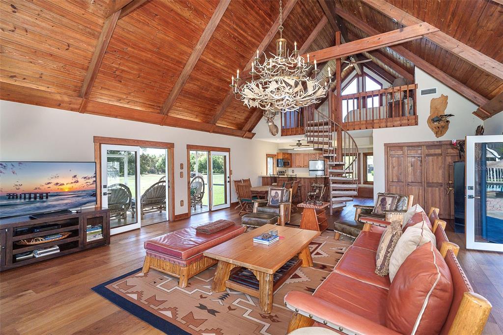 9299 Southwest Lipe Road Arcadia, FL 34269 - Photo 44 of 68 a living room with furniture a large window and a fireplace