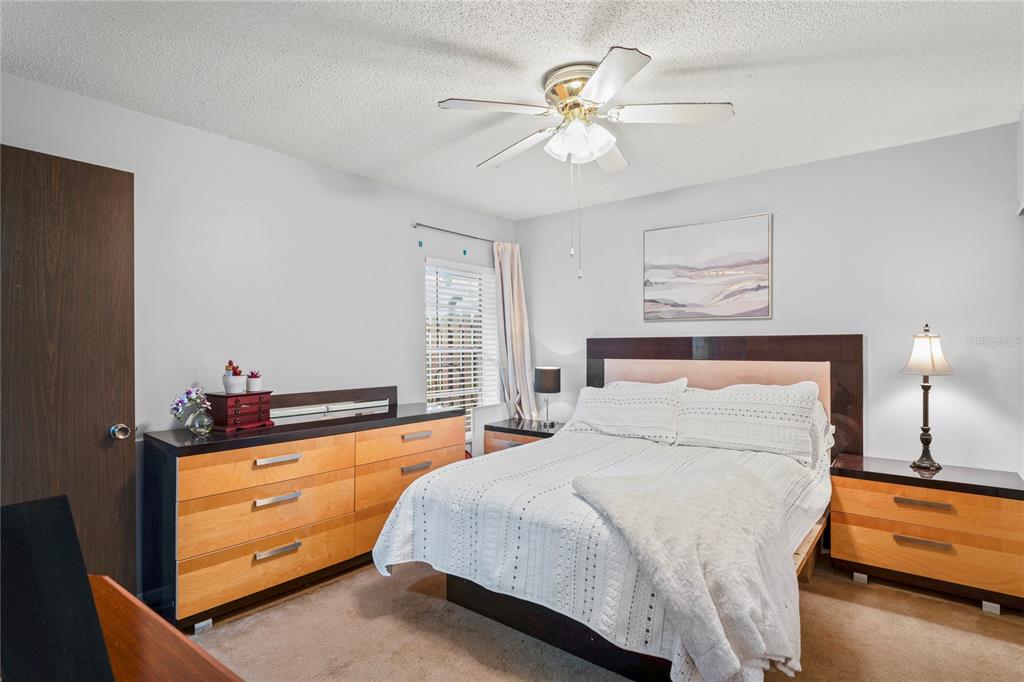 802 Antler Court Brandon, FL 33511 - Photo 11 of 37 a bedroom with a bed and a chandelier