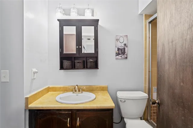 a bathroom with a toilet sink and mirror