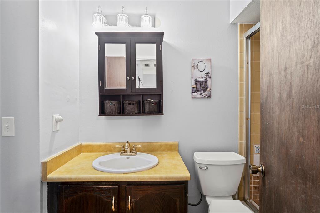 802 Antler Court Brandon, FL 33511 - Photo 14 of 37 a bathroom with a toilet sink and mirror