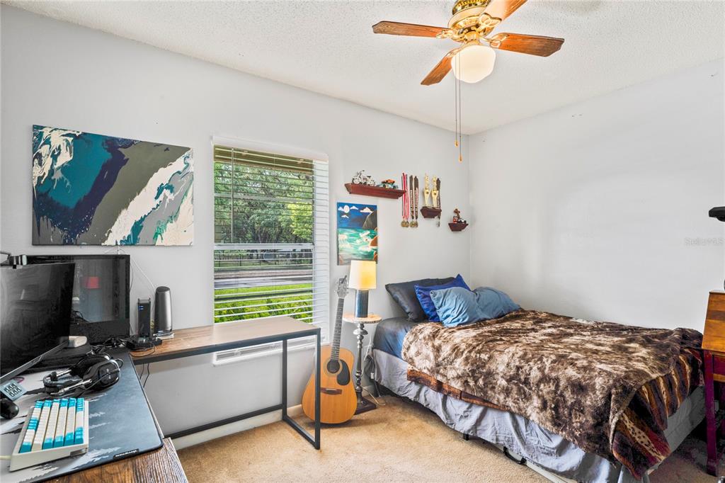 802 Antler Court Brandon, FL 33511 - Photo 16 of 37 a bedroom with a bed and a chandelier