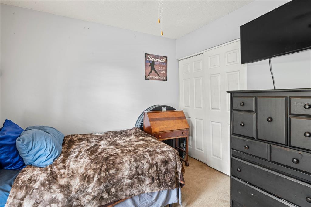 802 Antler Court Brandon, FL 33511 - Photo 18 of 37 a bedroom with a bed and dresser