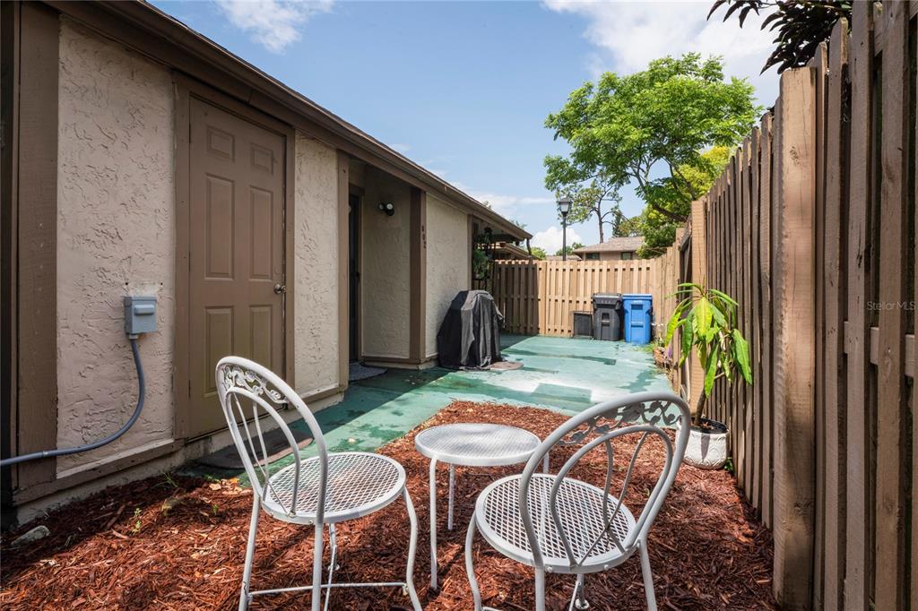 802 Antler Court Brandon, FL 33511 - Photo 25 of 37 a backyard of a house with barbeque oven table and chairs